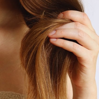 Femme ayant ses cheveux dans les mains