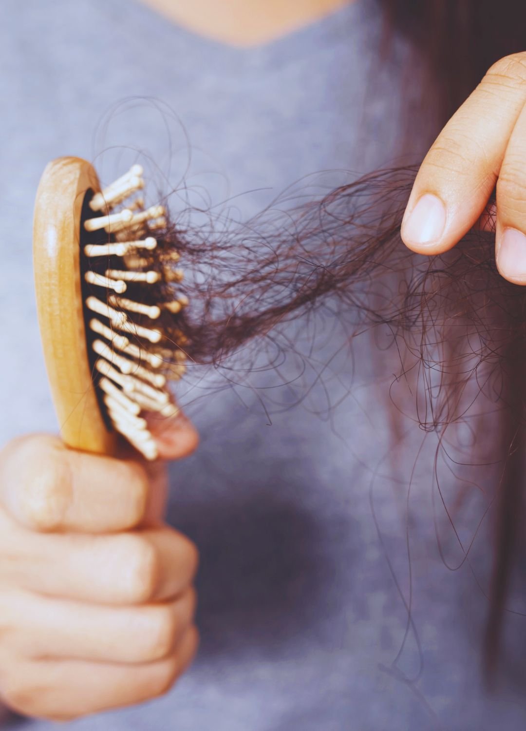 Femme ayant une brosse à cheveux avec plein de cheveux morts